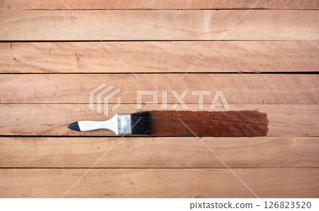 Paint brush and wood material in construction work. 126823520