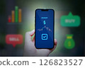 holding smartphone with market stock app 126823527