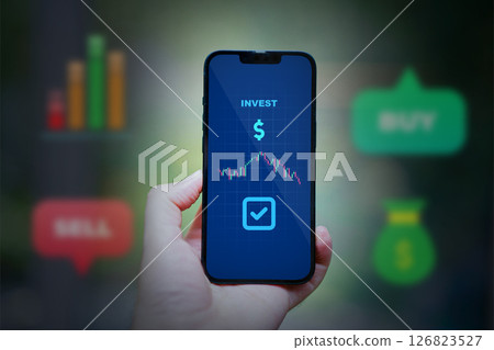 holding smartphone with market stock app 126823527