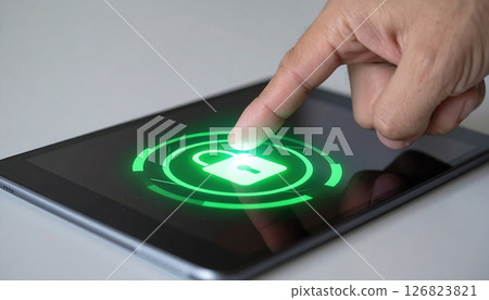 Hand pressing fingerprint scanner on smartphone screen with green security lock icon for biometric authentication 126823821