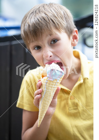 Happy little toddler boy eating colorful ice cream in summer, outdoors 126824218