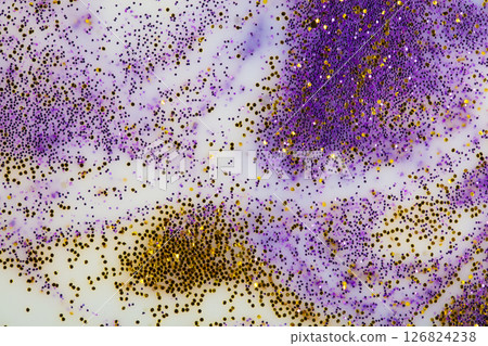 Festive or glamorous background. Gold and purple sparkles scattered on a white background. Festive or glamorous background. Gold and purple sparkles scattered on a white background. 126824238