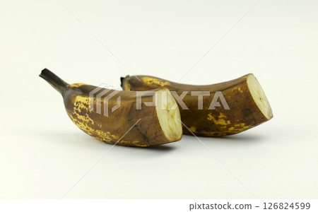 Ripened bananas on a plain background. bananas cut in half 126824599