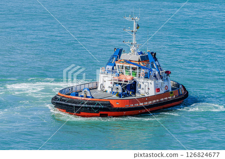 Modern tugboat maneuvering in open sea 126824677
