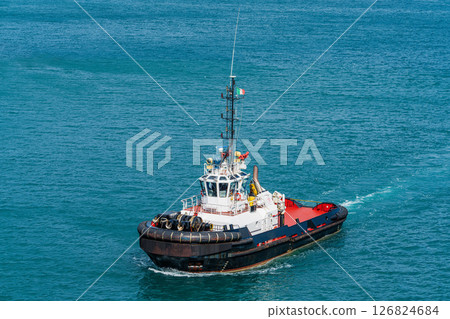Tugboat sailing in open sea 126824684