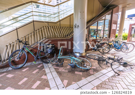 Yokohama cityscape in Japan Strong winds... An abandoned bicycle was lying down under the "Yokohama West Exit First Pedestrian Bridge" at the west exit of Yokohama Station, where the wind was strong. 126824819