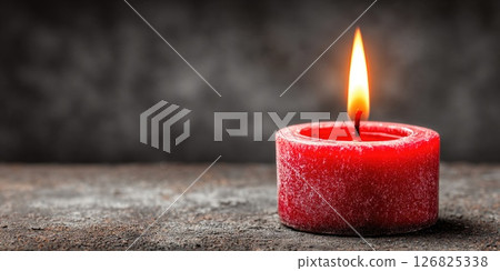 Red Votive Candle Burning on Rustic Surface Red Votive Candle Burning on Rustic Surface 126825338