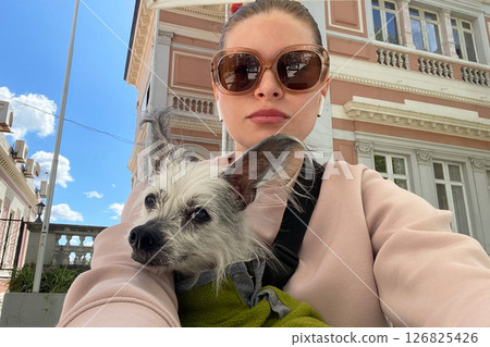 Woman and her cute hairless dog taking a selfie outdoors 126825426