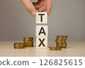 Businessman stacking wooden cubes with tax 126825615