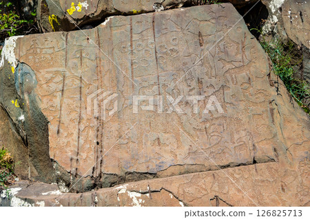 Petroglyphs at Kalbak-Tash rock art complex Altai Russia. Ancient carvings showcasing prehistoric cultural heritage. 126825713