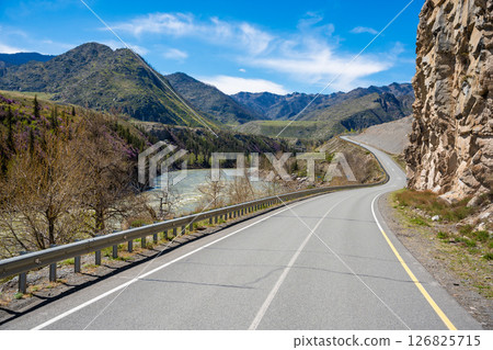 Road stretching along the Chuya River on Chuysky Trakt in Altai Russia. Scenic mountain route through wild Siberian landscape. 126825715