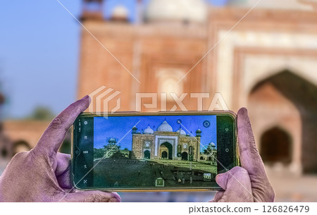 Traveller woman taking picure of Taj Mahal an UNESCO world heritage site at Agra, Uttar Pradesh, India. Traveller woman taking picure of Taj Mahal an UNESCO world heritage site at Agra, Uttar Pradesh, India. 126826479