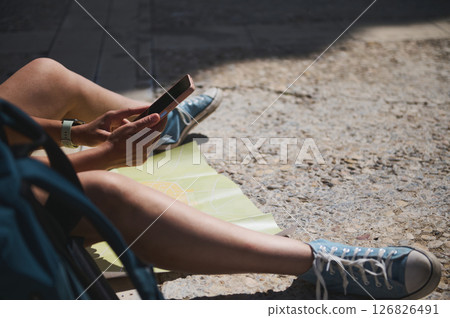 Traveler Exploring a Scenic Medieval Village with Map and Smartphone 126826491