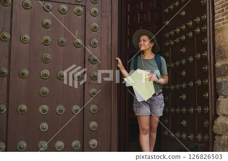 Traveler Exploring a Historic Village with Map and Backpack Traveler Exploring a Historic Village with Map and Backpack 126826503