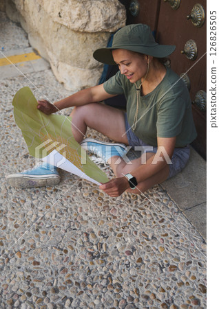 Traveler Examining Map of Historic Mediterranean Village 126826505