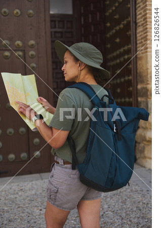 Traveler Exploring a Medieval Historic City with Map and Backpack Traveler Exploring a Medieval Historic City with Map and Backpack 126826544
