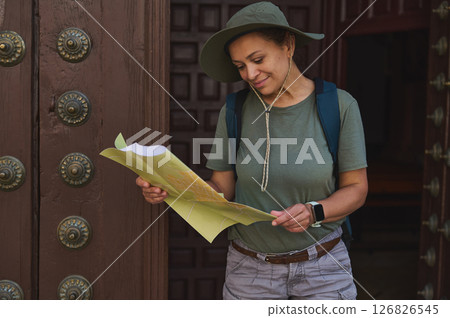 Traveler Exploring Historical Landmarks with a Map in a Historic City Setting Traveler Exploring Historical Landmarks with a Map in a Historic City Setting 126826545