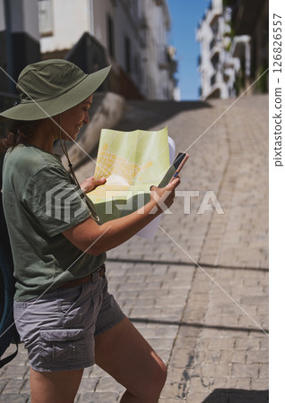 Traveler Exploring Spanish Village Holding Map Outdoors 126826557