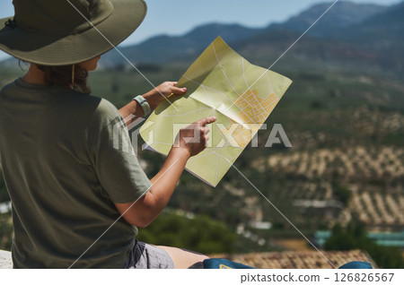 Traveler Exploring Medieval Village with Scenic Mountain Views 126826567