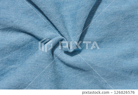 Close-up of the texture of thin light blue denim jeans Close-up of the texture of thin light blue denim jeans 126826576