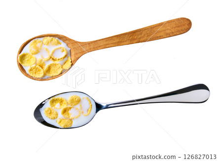 Spoon of tasty crispy corn flakes with milk isolated on white background, top view. Spoon of tasty crispy corn flakes with milk isolated on white background, top view. 126827013