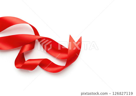 Bright red ribbon with a curved edge on a white background. Space for text. 126827119