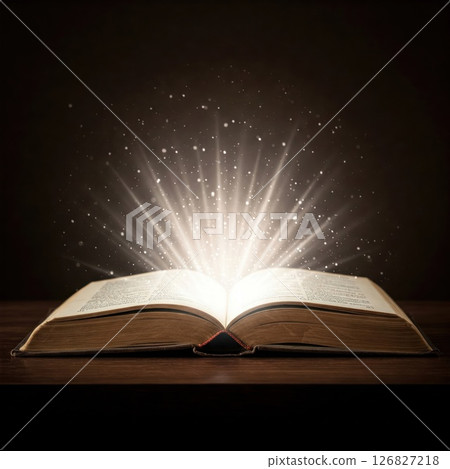 A magical light emanating from an open book. A magical light emanating from an open book. 126827218