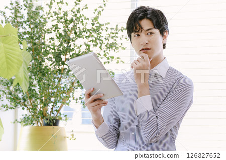 businessman operating a tablet businessman operating a tablet 126827652