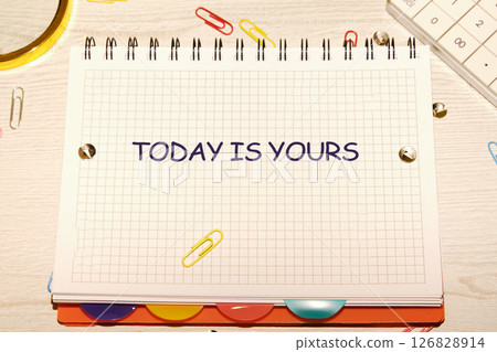 Motivational words TODAY IS YOURS, a motivational message written on a grid notebook 126828914