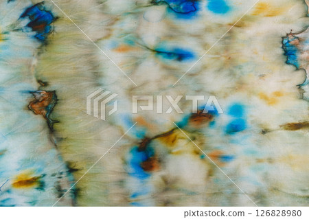 abstract pattern on silk fabric texture in blue, yellow, green colors 126828980