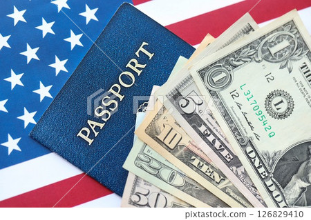 American US dollars money bills and passport with american flag 126829410
