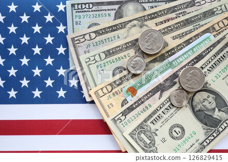 American US dollars money bills, green card on American flag close up 126829415