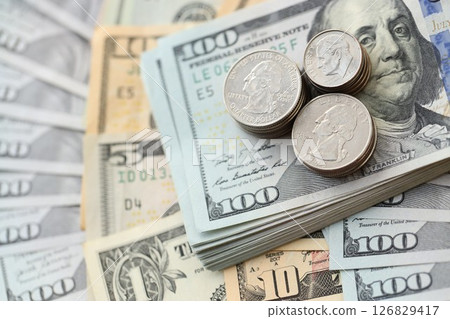 American US dollars money bills and coins close up in big amount American US dollars money bills and coins close up in big amount 126829417