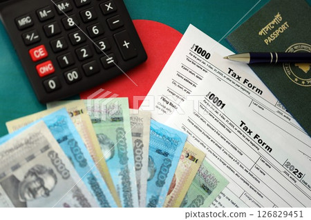Bangladeshi taka money bills lies on table with pen, calculator, passport and tax forms Bangladeshi taka money bills lies on table with pen, calculator, passport and tax forms 126829451