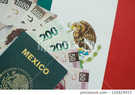 Mexican pesos money bills in big amount and passport lies on Mexico flag close up 126829455