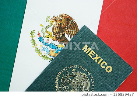Mexican passport lies on Mexico flag close up. Travel and citizenship 126829457