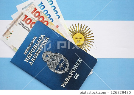 Argentine pesos money bills in big amount and passport lies on Argentina flag close up 126829480