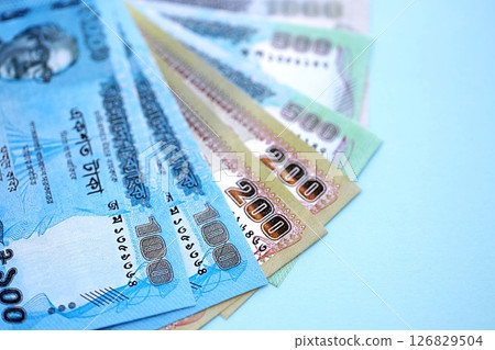 Bangladeshi taka money bills in big amount lies on teal color table close up 126829504