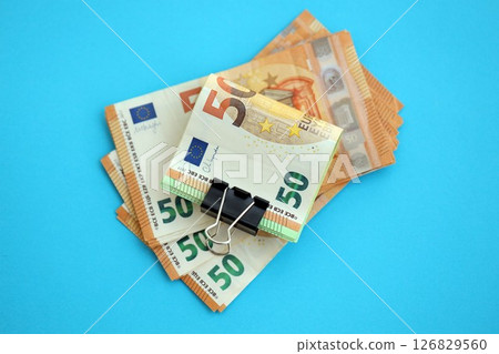 Big amount of european euro currency money notes on blue color table close up Big amount of european euro currency money notes on blue color table close up 126829560