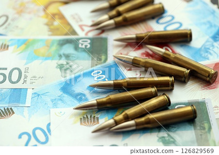 Israel New Shekels banknotes and bullets. The current Israel money bills and ammo 126829569