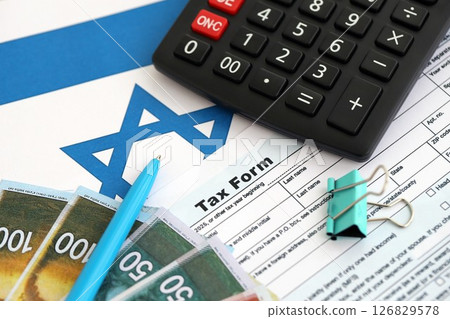 Israel new shekels money with calculator and tax form on flag. The current Israel money and blank Israel new shekels money with calculator and tax form on flag. The current Israel money and blank 126829578
