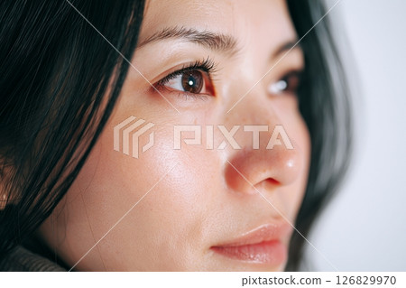 "AI generated image" of a black-haired adult woman 126829970