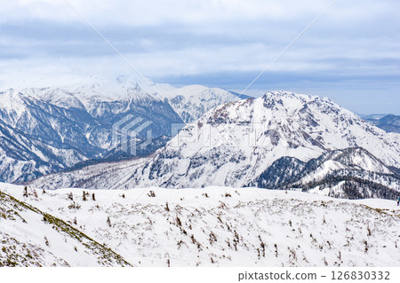 Mt. Norikura and Mt. Yakedake seen from Mt. Nishihomaruyama. Climbing Mt. Dokubetsu in the snowy season 126830332