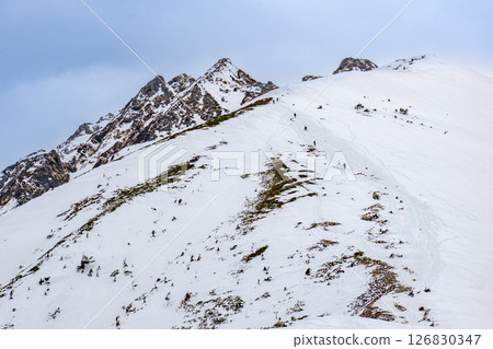 Pyramid Peak and Dokubyou of Nishihotakadake. Climbing Dokubyou snow mountain of Nishihotakadake in the remaining snow season. 126830347