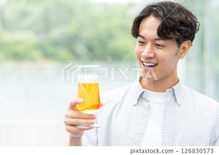 一名男子正在喝美味的啤酒。 126830573