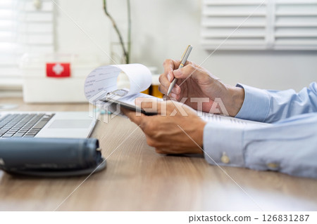 Healthcare professional using laptop to document patient information Healthcare professional using laptop to document patient information 126831287