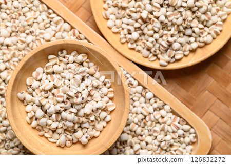 Dried Job's tears or adlay millet seeds in wooden bowl, Food ingredient, Top view 126832272