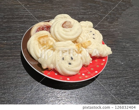 Cute cookies on a red plate Cute cookies on a red plate 126832404