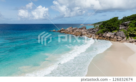 A pristine coastline with clear water and beach with white sand. La Digue, Seychelles. 126832674