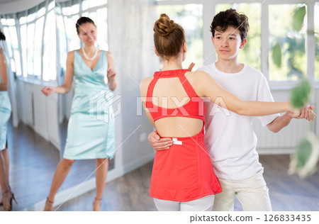 Girl and boy dancing slow ballroom dance in choreography studio 126833435